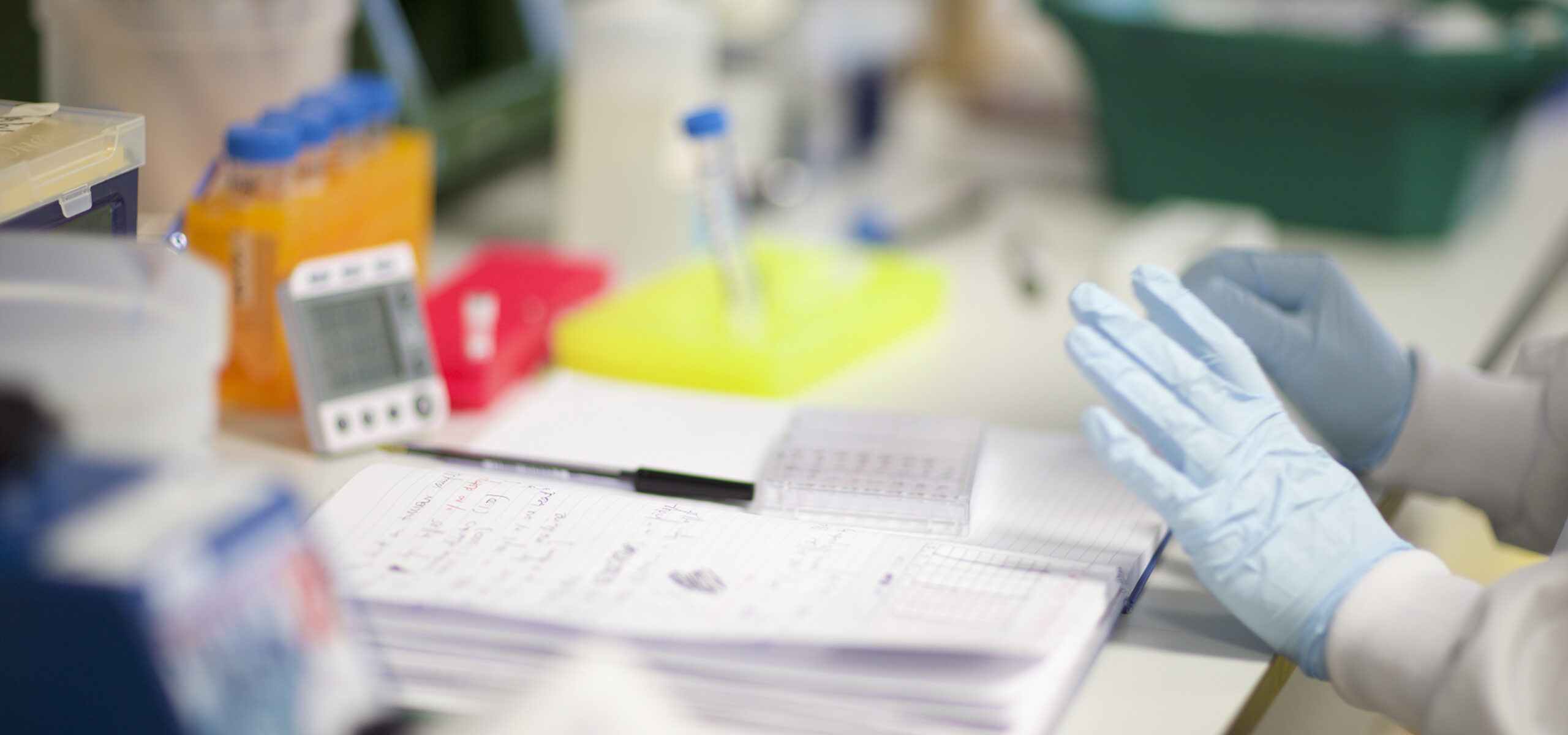 Person writing in a laboratory book