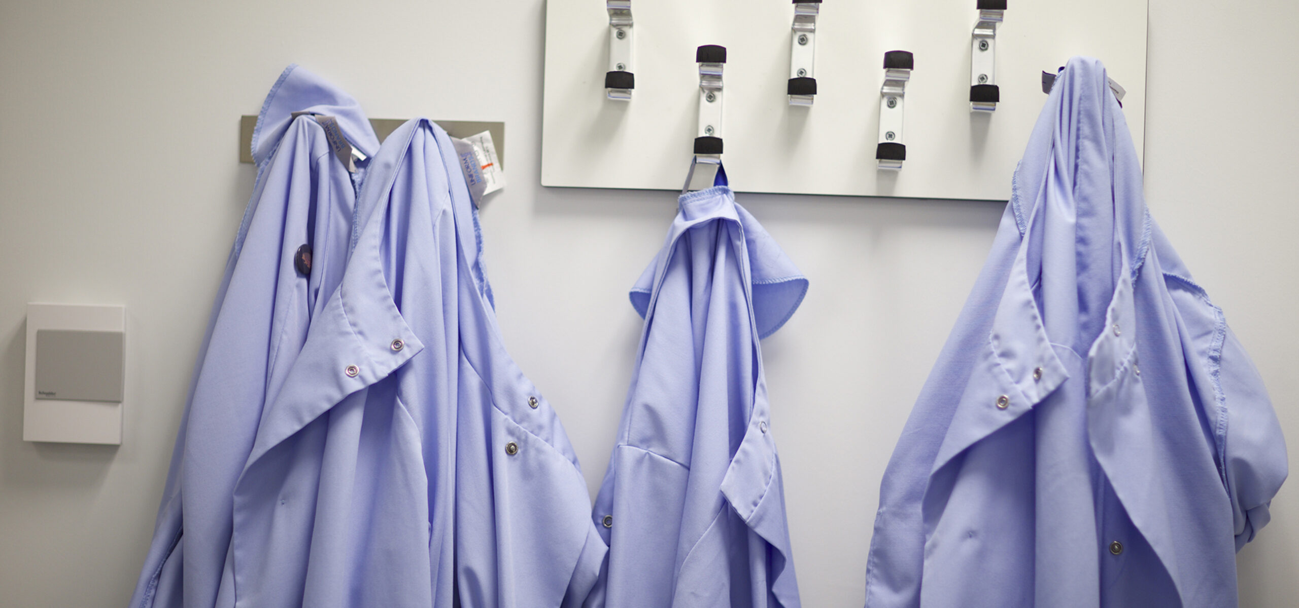 Lab coats on hooks