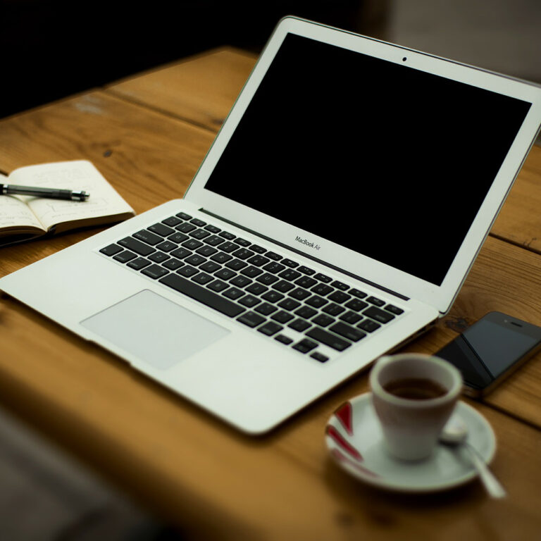 Laptop and notepad on a desk