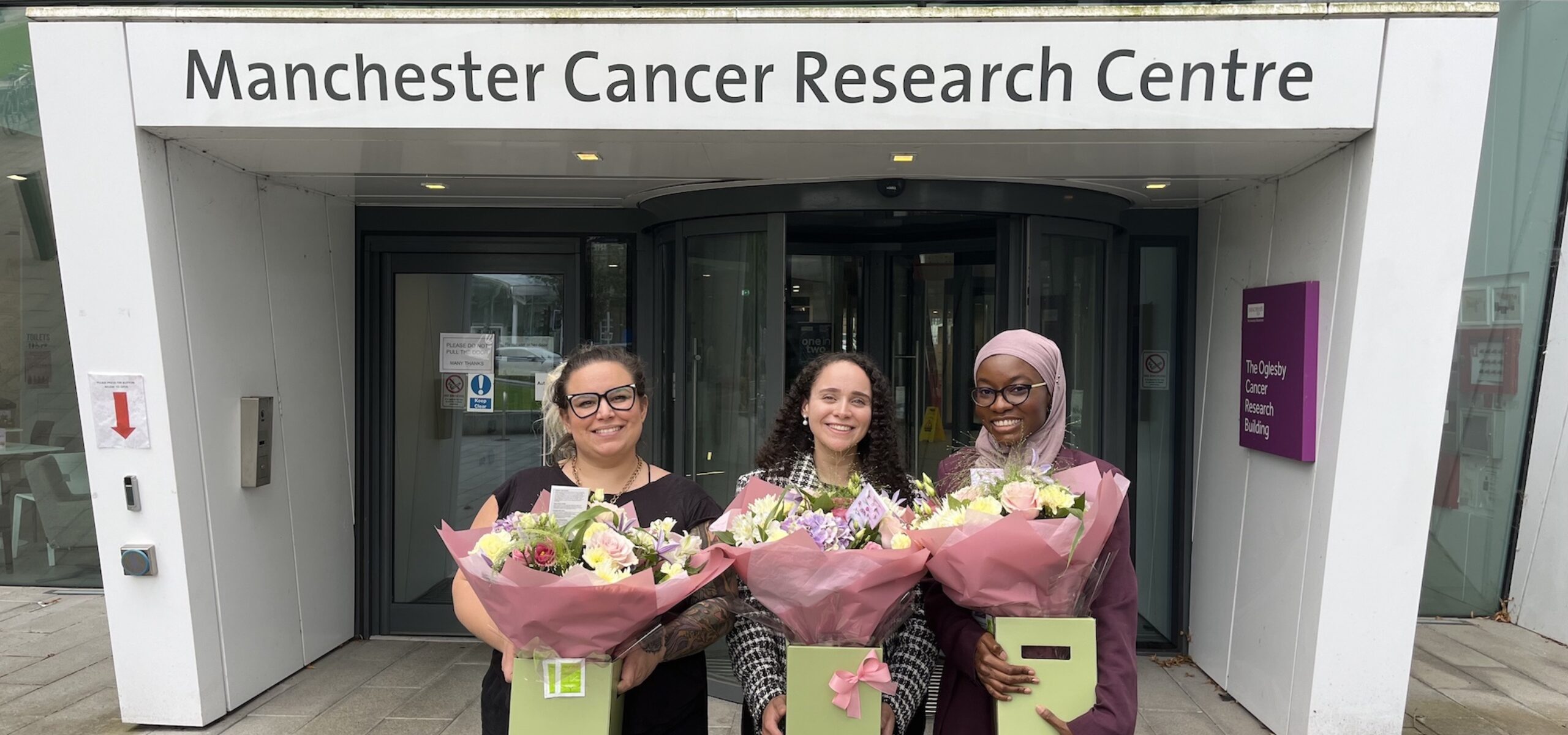 MB-PhD students in front of the OCRB in Manchester, Left to right: Macarena, Nadin, Hadiyat