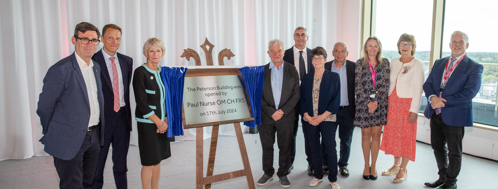 Left to Right: Andy Burnham, Dr Iain Foulkes, Professor Dame Nancy Rothwell, Professor Sir Paul Nurse, Roger Spencer, Adele Adams, Professor Nic Jones, Professor Caroline Dive, Lord-Lieutenant of Greater Manchester, Diane Hawkins, and Professor Robert Bristow at the official opening of the Paterson Building on 17th July 2024.