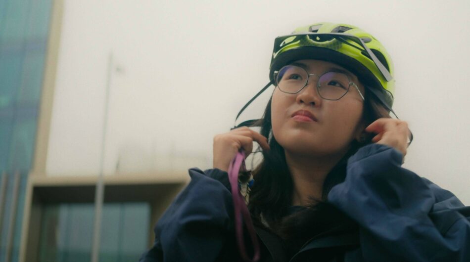 Jean wearing a helmet and stood outside of the Paterson Building