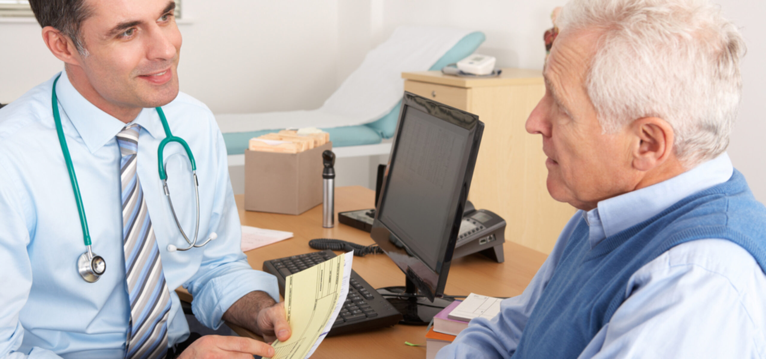 British GP speaking with a man in a GP clinic environment